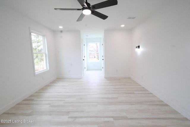 empty room featuring ceiling fan and light hardwood / wood-style flooring