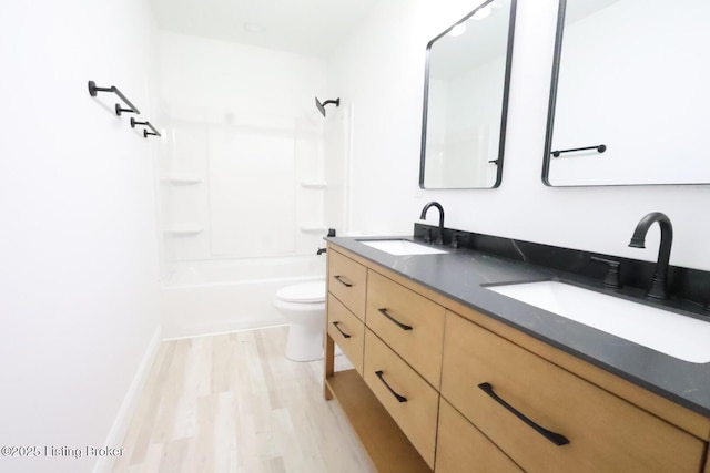 full bathroom featuring vanity, toilet, shower / tub combination, and wood-type flooring