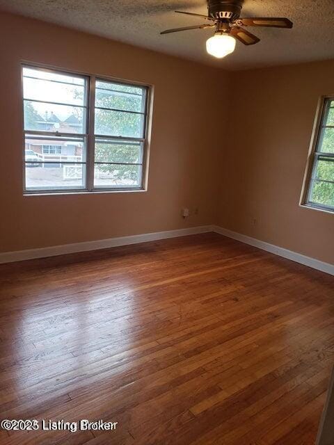 spare room featuring hardwood / wood-style floors, ceiling fan, and a textured ceiling