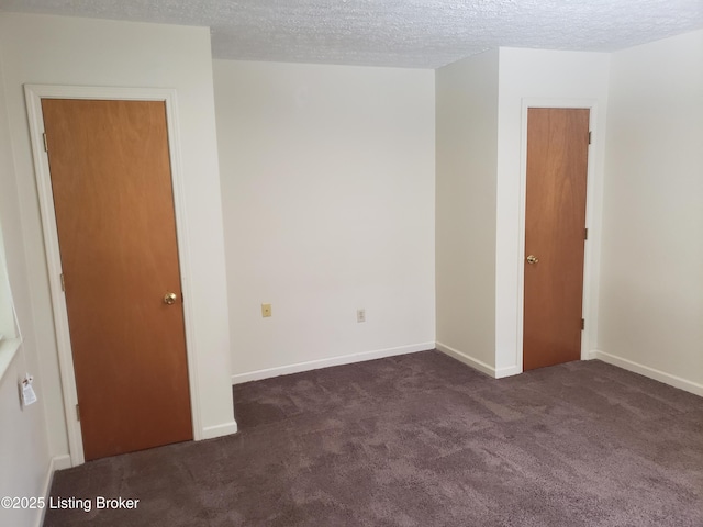 carpeted spare room with a textured ceiling