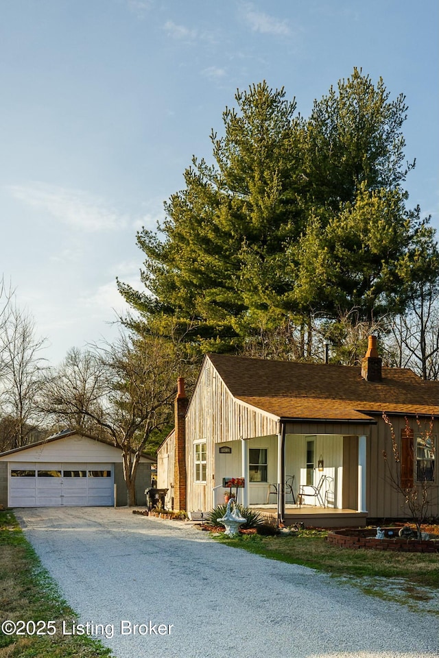 view of front of property featuring an outbuilding, covered porch, and a garage