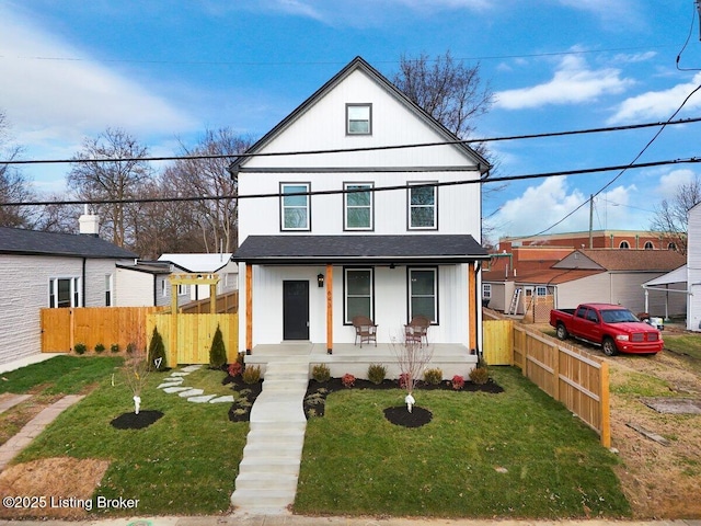 view of front of house with covered porch and a front yard