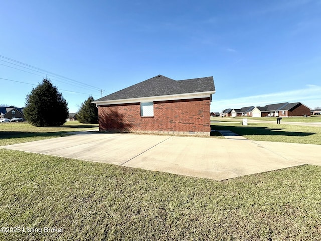 view of side of property with a lawn