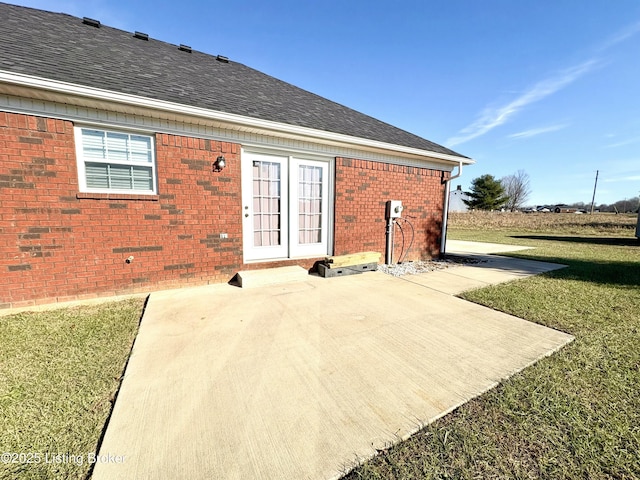 rear view of property with a yard and a patio