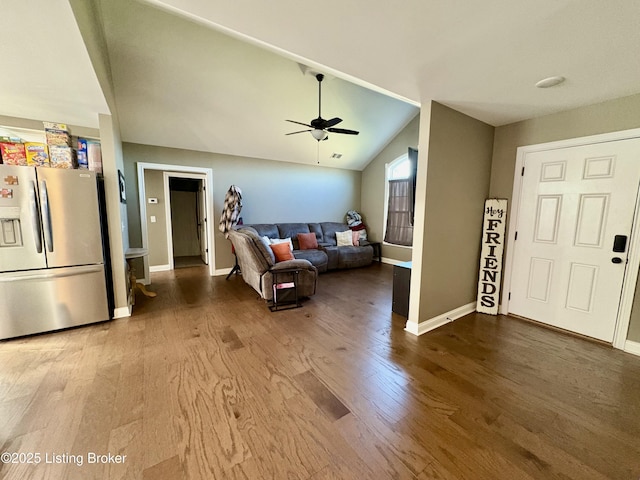 living room featuring wood-type flooring, vaulted ceiling, and ceiling fan