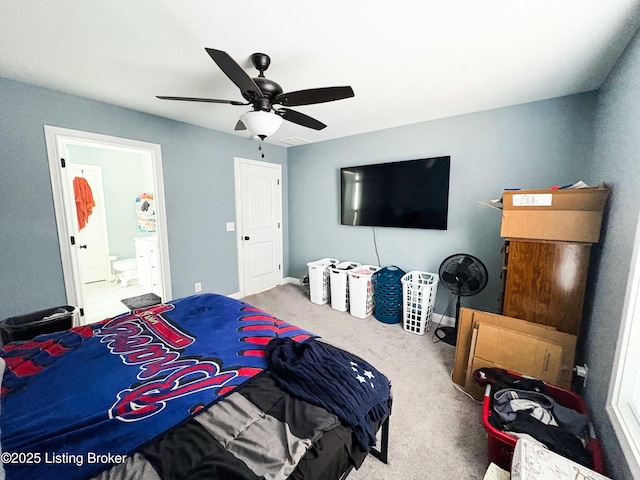 carpeted bedroom with ceiling fan and connected bathroom