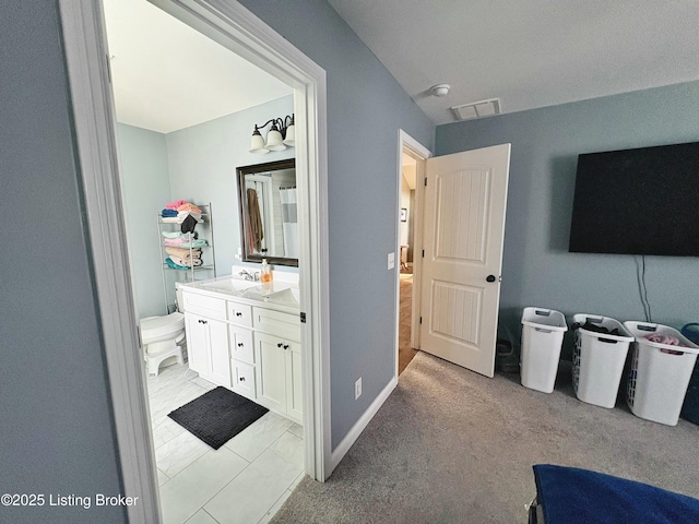 bathroom featuring vanity and toilet