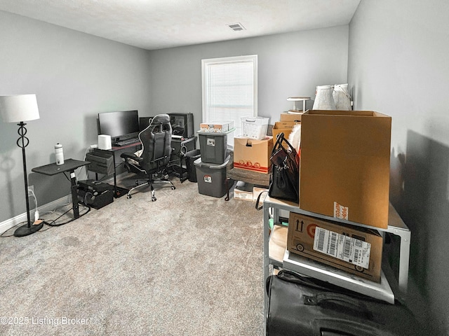 carpeted office space featuring a textured ceiling