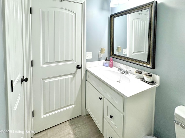 bathroom featuring vanity and toilet