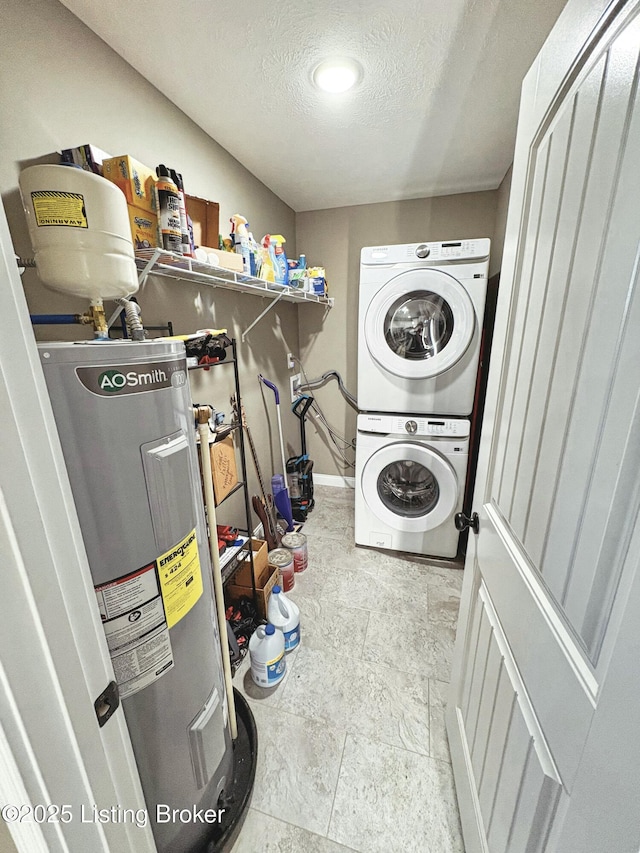 laundry area featuring a textured ceiling, electric water heater, and stacked washer and dryer