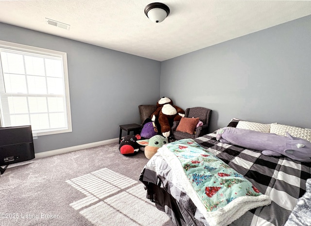 carpeted bedroom with multiple windows