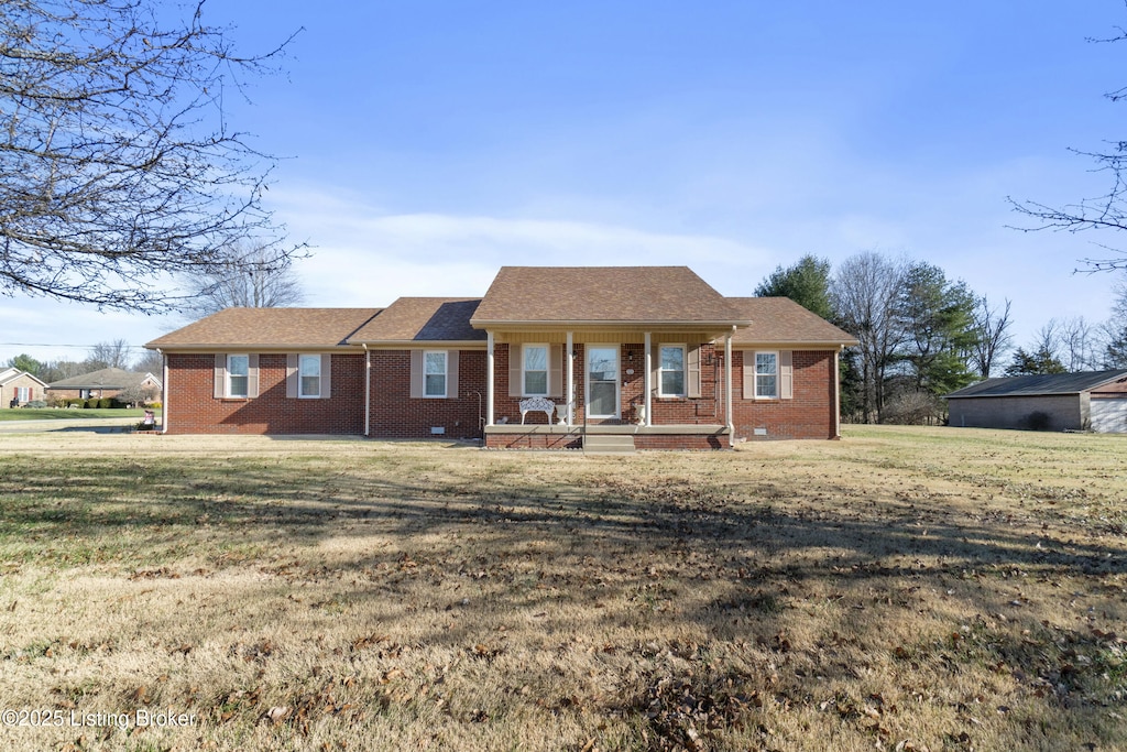 ranch-style house featuring a porch and a front yard