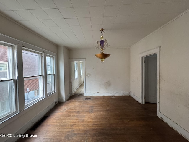 unfurnished dining area featuring dark wood-type flooring