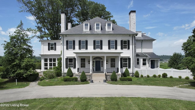 colonial inspired home featuring a porch