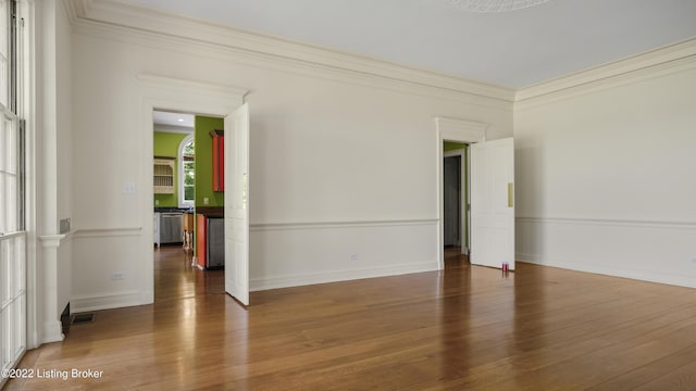 unfurnished room featuring ornamental molding and dark wood-type flooring