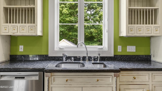 kitchen featuring dishwasher, cream cabinetry, and sink