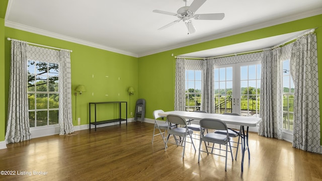 dining space featuring ceiling fan, crown molding, and dark wood-type flooring