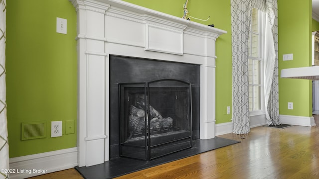 interior details featuring hardwood / wood-style floors and ornamental molding