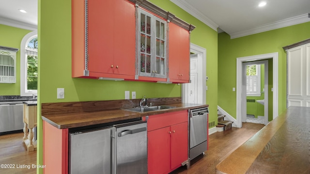 kitchen featuring dishwasher, crown molding, sink, and dark wood-type flooring