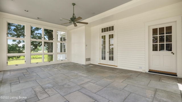 unfurnished sunroom with ceiling fan and french doors