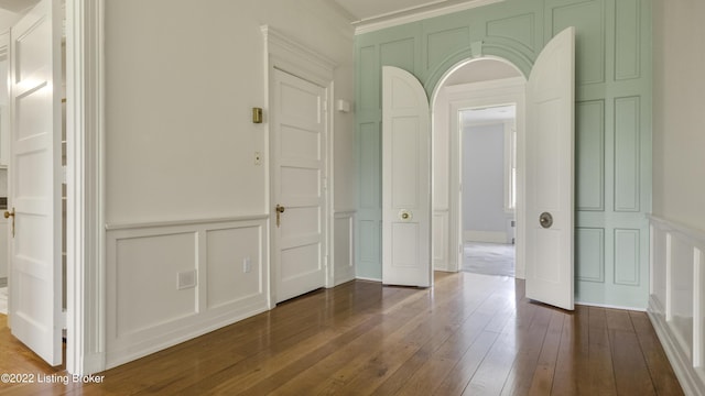 interior space featuring crown molding and dark wood-type flooring