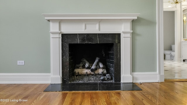 details featuring hardwood / wood-style floors and a tiled fireplace