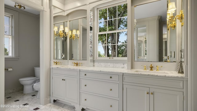 bathroom featuring vanity, toilet, and a bidet