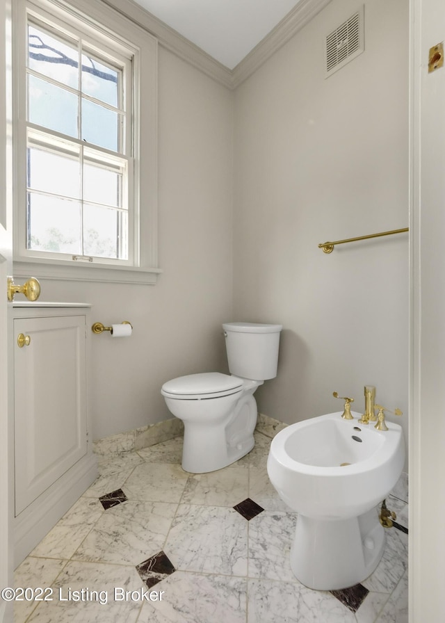 bathroom with toilet, a bidet, and ornamental molding