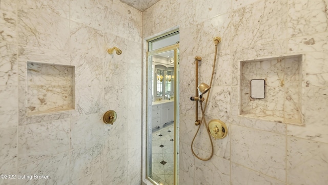 bathroom featuring vanity and tiled shower