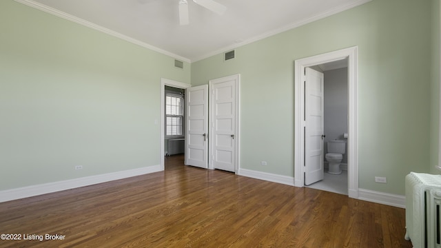 unfurnished bedroom featuring ceiling fan, crown molding, dark wood-type flooring, radiator heating unit, and connected bathroom