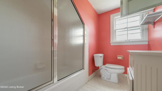 bathroom with tile patterned flooring, bath / shower combo with glass door, and toilet