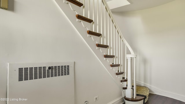 stairs with radiator and hardwood / wood-style flooring