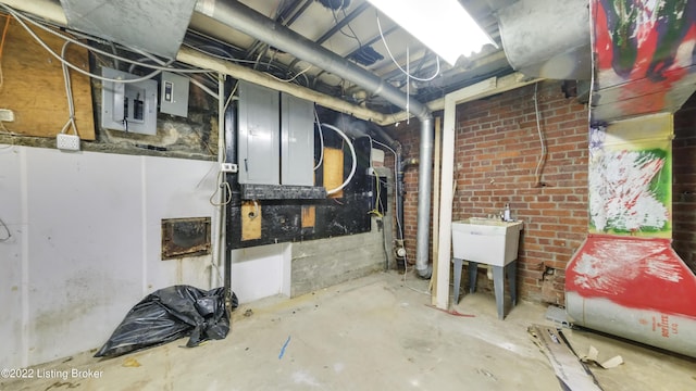 basement featuring electric panel and sink