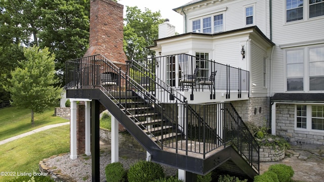 back of property featuring a yard and a deck