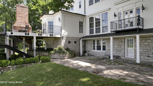 rear view of property featuring a yard