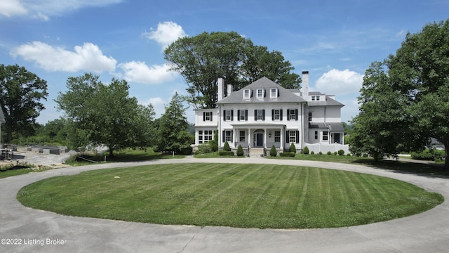 view of front facade with a front yard and a porch