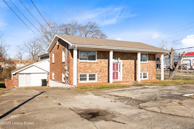 bi-level home with an outbuilding and a garage