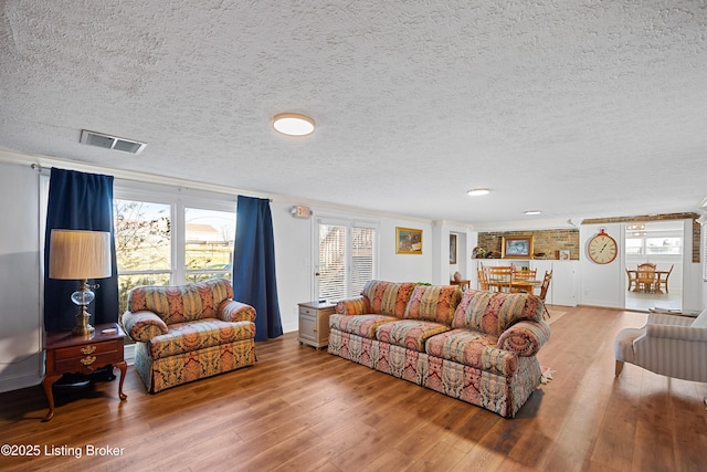 living room with hardwood / wood-style flooring and a textured ceiling