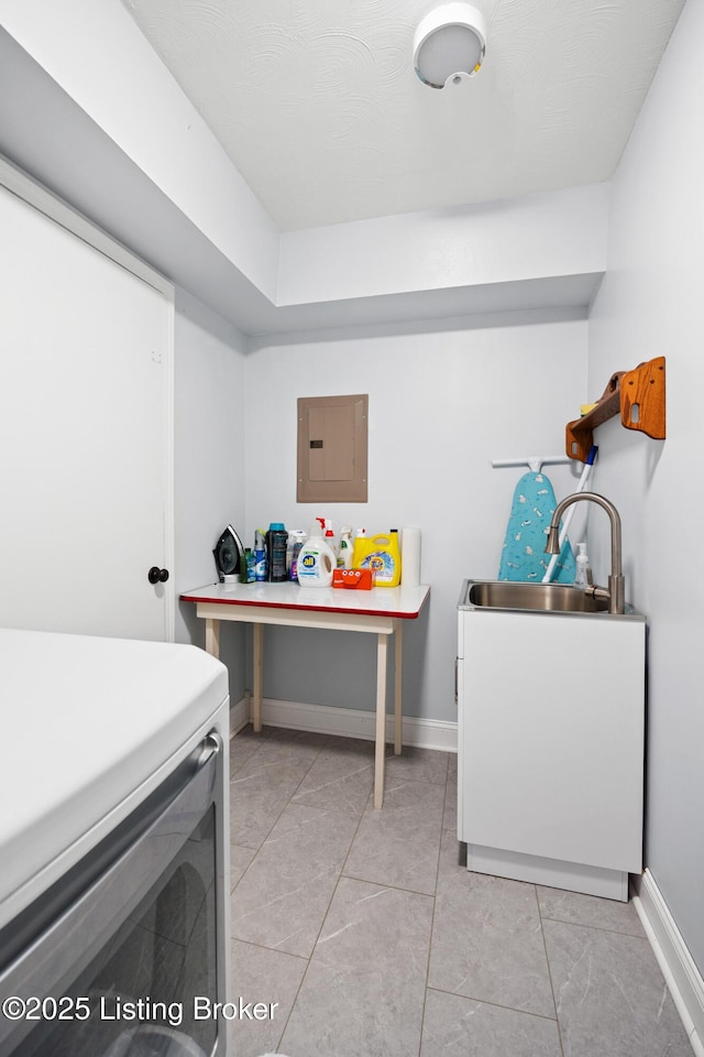 clothes washing area featuring washer / clothes dryer, sink, and electric panel