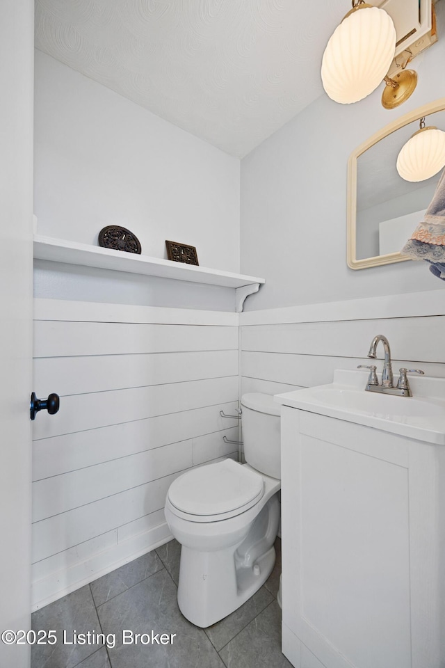 bathroom featuring tile patterned floors, vanity, and toilet