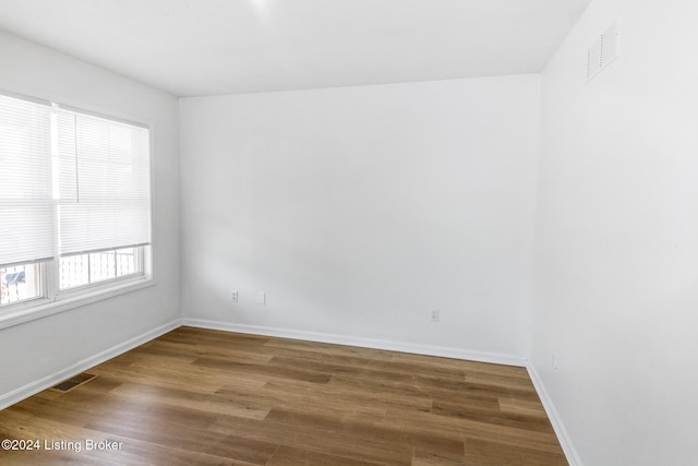 unfurnished room featuring hardwood / wood-style flooring