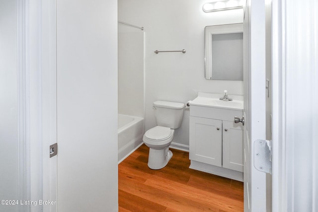 bathroom featuring hardwood / wood-style flooring, vanity, and toilet