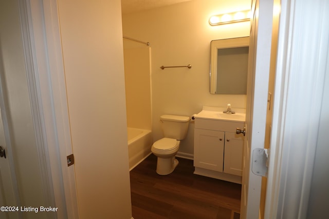 full bathroom featuring hardwood / wood-style floors, vanity, shower / bath combination, and toilet