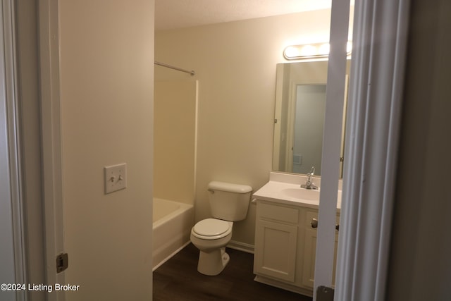 full bathroom featuring hardwood / wood-style flooring, vanity,  shower combination, and toilet