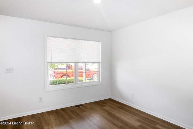 spare room featuring dark hardwood / wood-style flooring