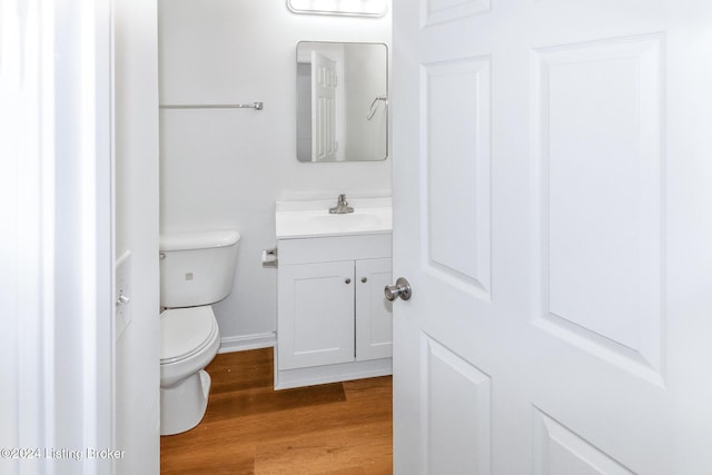 bathroom featuring hardwood / wood-style flooring, vanity, and toilet