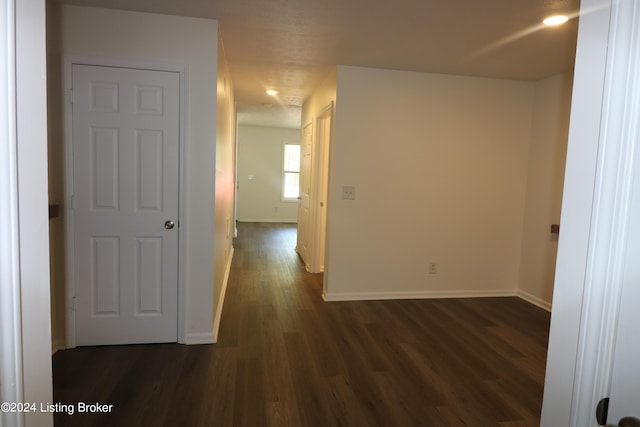 corridor with dark hardwood / wood-style floors