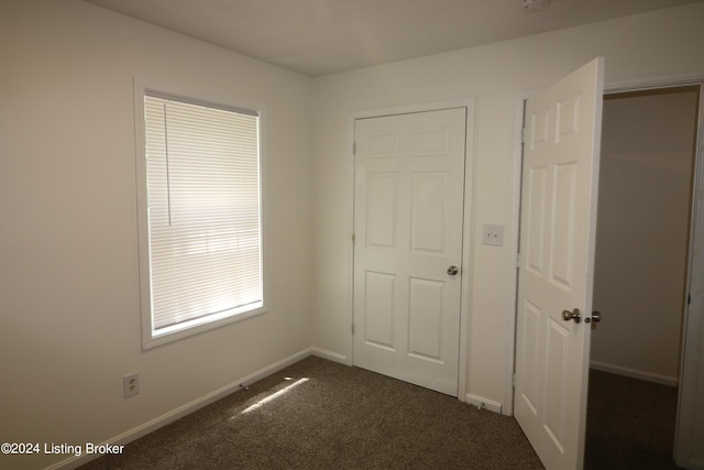 unfurnished bedroom featuring dark colored carpet