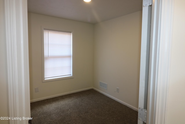 carpeted spare room featuring plenty of natural light