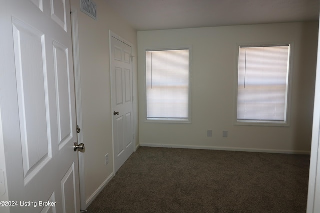 carpeted spare room with plenty of natural light